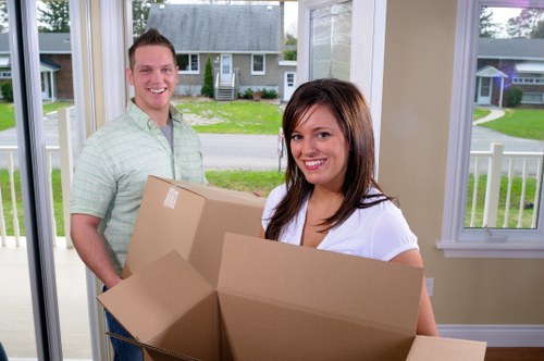 Boxes and furniture arranged to show cubic-yard pricing for a removal job