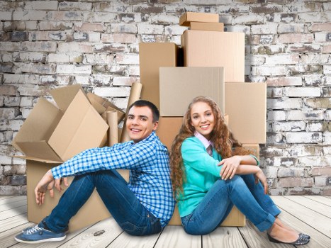 Packing boxes and furniture being loaded into a van