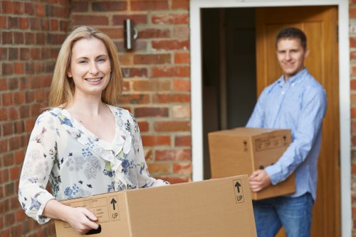 Removal team handling furniture in a West Kensington flat move
