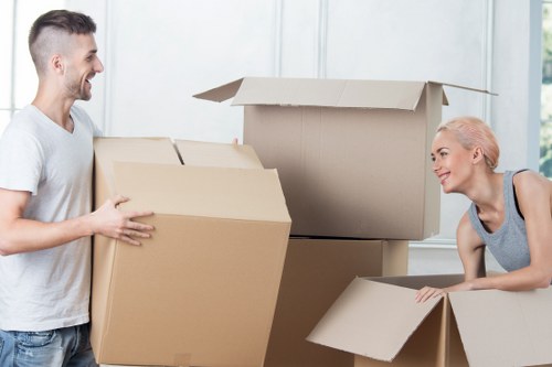 Removal staff using PPE while handling furniture safely