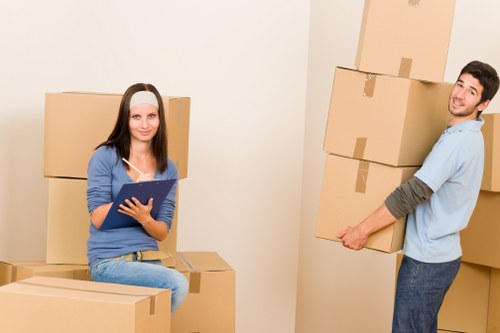 Packed boxes and furniture ready for flat removals in West Kensington
