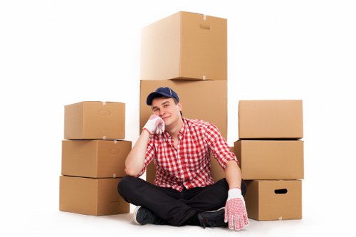 Professional movers packing fragile household items safely